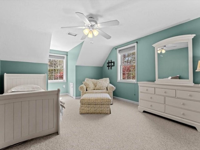 carpeted bedroom with baseboards, multiple windows, lofted ceiling, and ceiling fan