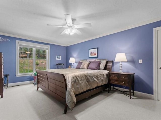 carpeted bedroom with crown molding, baseboards, and ceiling fan