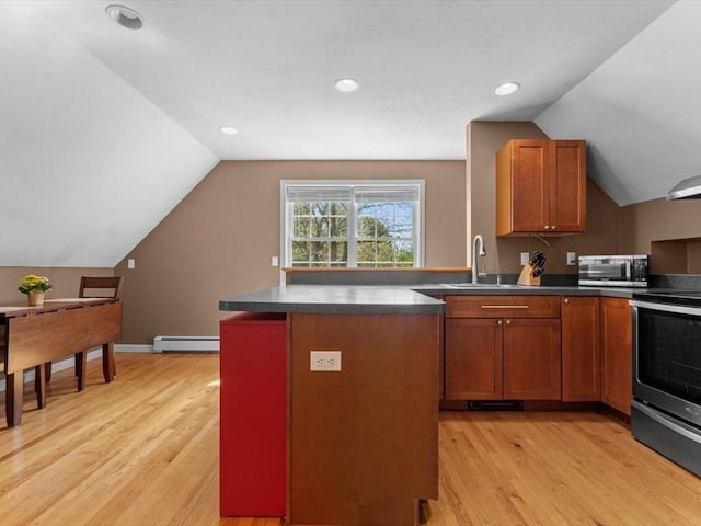kitchen with appliances with stainless steel finishes, light wood-style floors, vaulted ceiling, a sink, and a baseboard radiator
