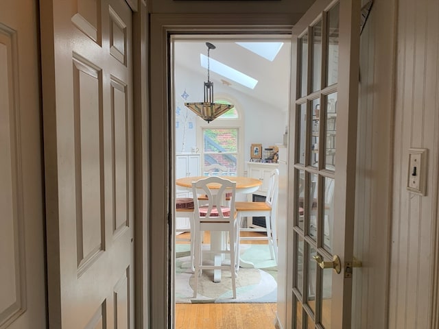 details with french doors, a skylight, and hardwood / wood-style flooring