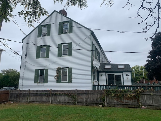 exterior space featuring cooling unit and a yard