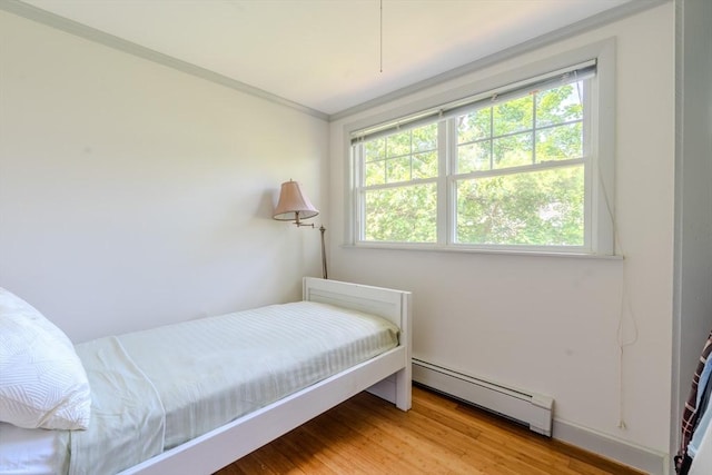 290 E St, Westwood, MA 02090 - bedroom featuring a baseboard radiator and light wood-style flooring