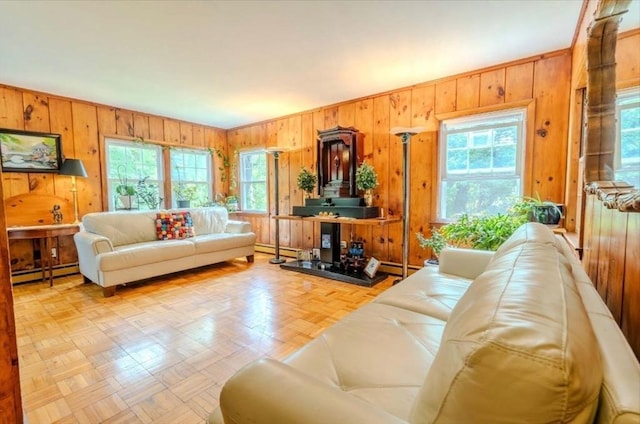 290 E St, Westwood, MA 02090 - living area with baseboard heating, wood walls, and healthy amount of natural light