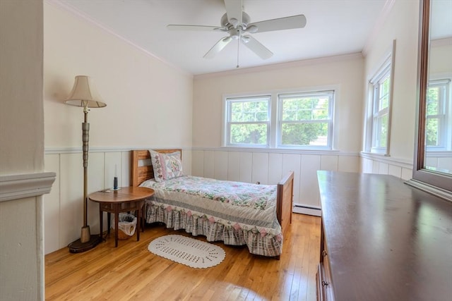 290 E St, Westwood, MA 02090 - bedroom featuring baseboard heating, multiple windows, light wood-style floors, a wainscoted wall, and ornamental molding