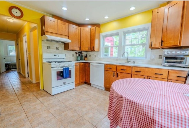 290 E St, Westwood, MA 02090 - kitchen with white appliances, a sink, under cabinet range hood, light countertops, and tasteful backsplash