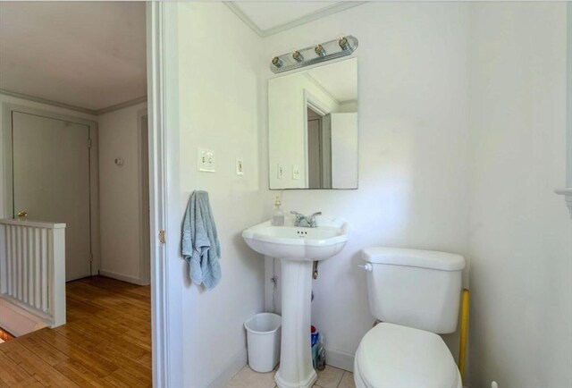 290 E St, Westwood, MA 02090 - half bathroom with toilet, a sink, baseboards, and wood finished floors