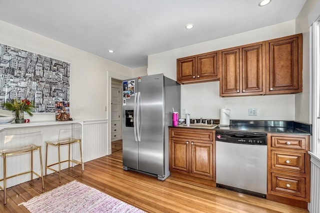 kitchen featuring light wood-type flooring, sink, and appliances with stainless steel finishes