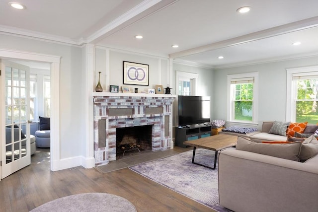 living room with a fireplace, ornamental molding, wood finished floors, recessed lighting, and baseboards