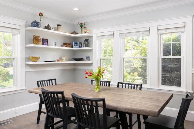 dining space featuring wood finished floors, ornamental molding, baseboards, and recessed lighting