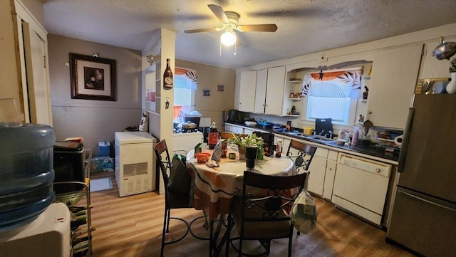 kitchen featuring white dishwasher, a textured ceiling, stainless steel refrigerator, white cabinets, and dark hardwood / wood-style floors