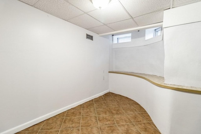 basement featuring a drop ceiling