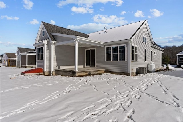 snow covered property with central AC unit