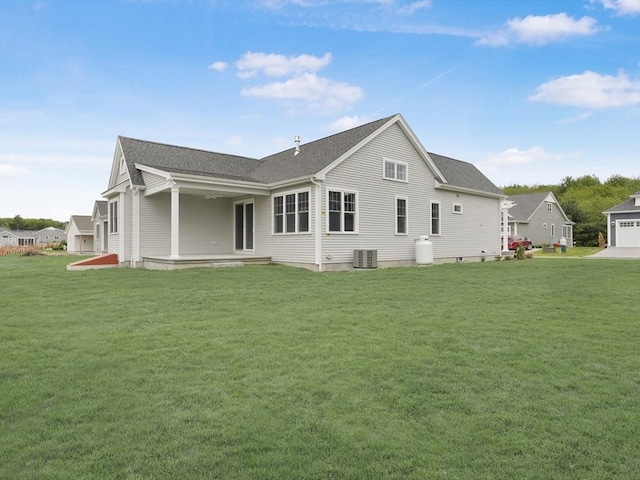 50 Yvonne Ln, Rehoboth, MA 02769 - back of property featuring cooling unit, a lawn, and roof with shingles