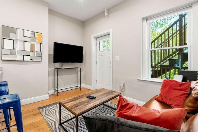 living area featuring baseboards and wood finished floors