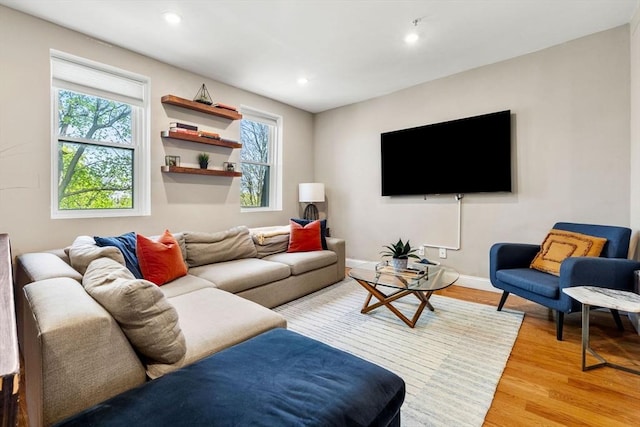 living room with light wood-style floors, baseboards, and recessed lighting