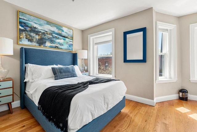 bedroom featuring baseboards and wood finished floors