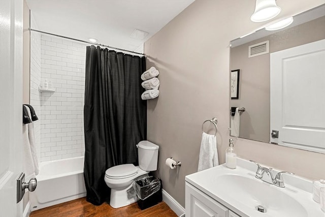 full bathroom with visible vents, wood finished floors, vanity, toilet, and shower / tub combo with curtain