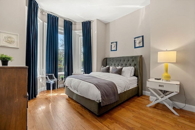 bedroom with baseboards and wood finished floors
