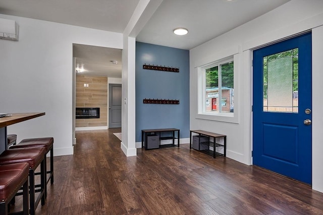 3030 Main St, Palmer, MA 01009 - foyer entrance with wood finished floors, a glass covered fireplace, and a wall unit AC