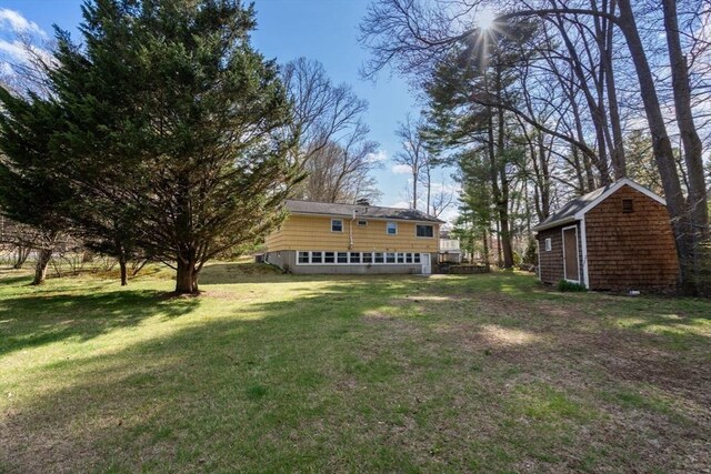 view of yard with a storage unit and an outbuilding