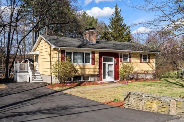 view of front of house featuring a front lawn and a chimney