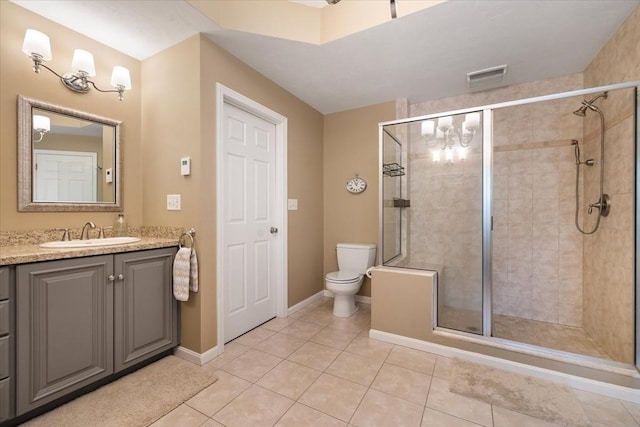 full bathroom featuring toilet, tile patterned floors, a shower stall, and vanity