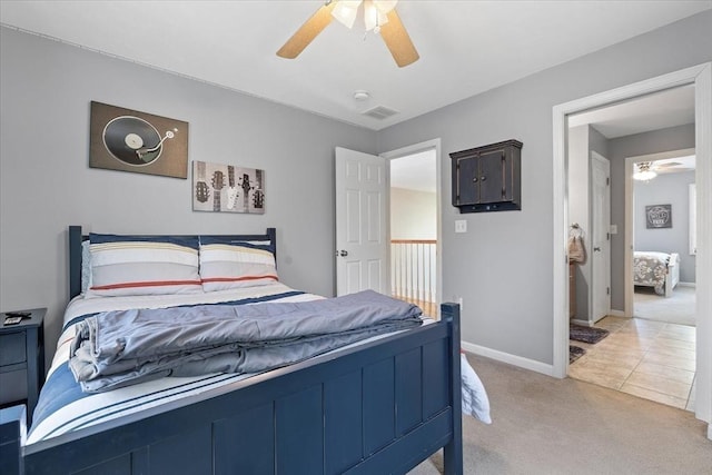 bedroom with ceiling fan, visible vents, light carpet, and baseboards