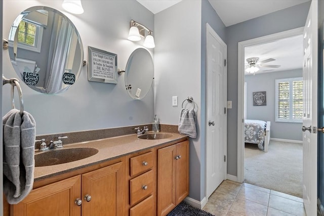 ensuite bathroom featuring double vanity, a sink, connected bathroom, and tile patterned floors