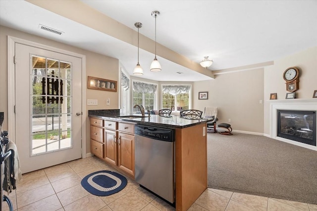 kitchen with brown cabinets, dishwasher, a peninsula, light tile patterned floors, and visible vents