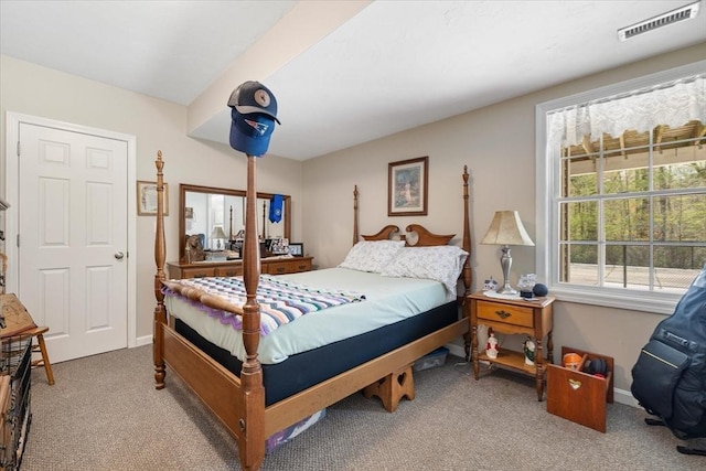 carpeted bedroom featuring baseboards and visible vents