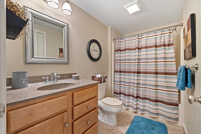 bathroom featuring toilet, a shower with shower curtain, tile patterned flooring, and vanity