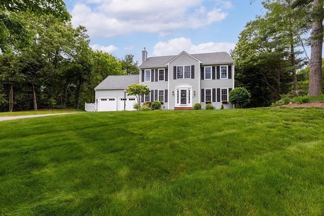 15 Pilgrim Rd, Mansfield, MA 02048 - colonial-style house with a chimney, an attached garage, and a front yard