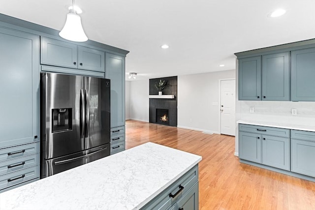 15 Pilgrim Rd, Mansfield, MA 02048 - kitchen featuring stainless steel fridge with ice dispenser, recessed lighting, light wood finished floors, a fireplace, and baseboards
