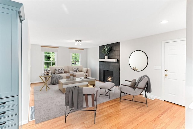 15 Pilgrim Rd, Mansfield, MA 02048 - living room featuring a tile fireplace, light wood finished floors, and baseboards