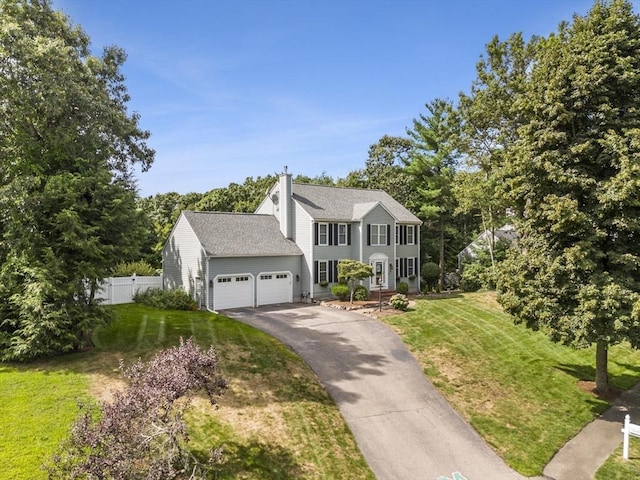 15 Pilgrim Rd, Mansfield, MA 02048 - colonial inspired home featuring a garage, asphalt driveway, a chimney, and roof with shingles