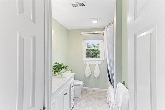 15 Pilgrim Rd, Mansfield, MA 02048 - bathroom featuring vanity, toilet, shower / bath combo with shower curtain, and baseboards