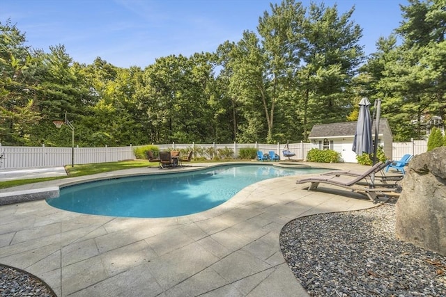 15 Pilgrim Rd, Mansfield, MA 02048 - view of pool with a patio area, a fenced backyard, an outdoor structure, and view of scattered trees
