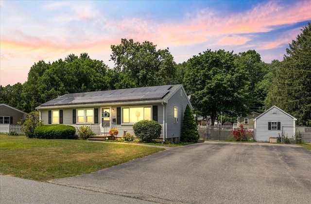 24 Alenclair, Amesbury, MA 01913 - view of front of property with roof mounted solar panels, driveway, and an outbuilding
