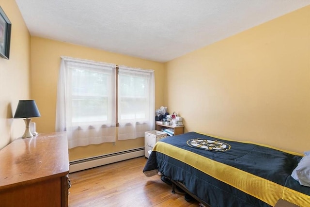 24 Alenclair, Amesbury, MA 01913 - bedroom featuring a baseboard heating unit and wood finished floors