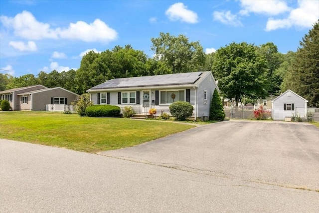 24 Alenclair, Amesbury, MA 01913 - single story home featuring a storage unit, solar panels, and view of wooded area