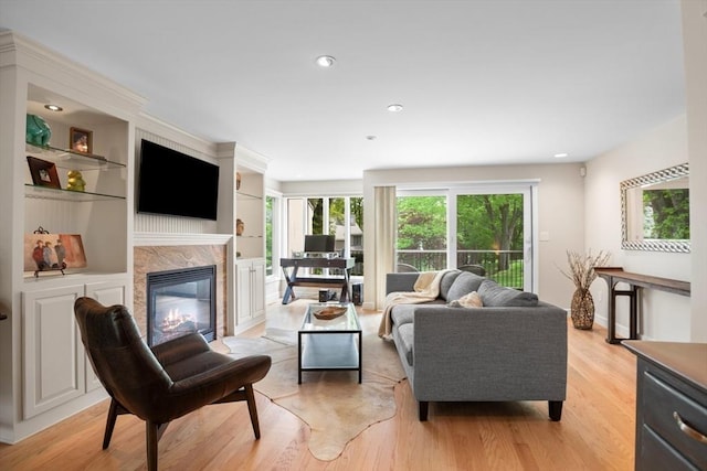 94 Mill Pond Unit 94, North Andover, MA 01845 - living room featuring healthy amount of natural light, light wood-style floors, a high end fireplace, and recessed lighting