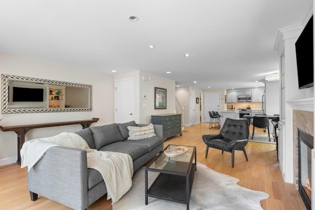 94 Mill Pond Unit 94, North Andover, MA 01845 - living area with light wood-type flooring, recessed lighting, stairway, a glass covered fireplace, and baseboards