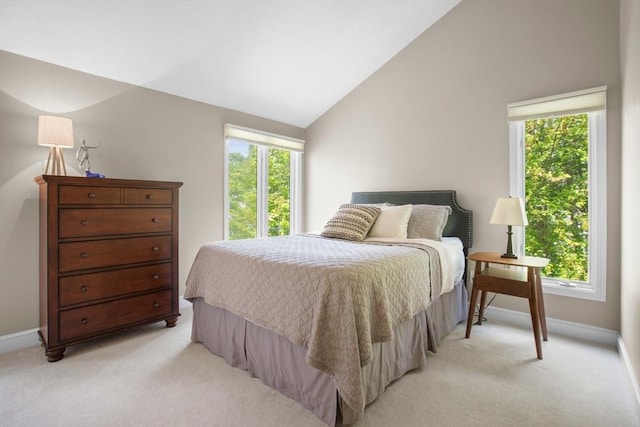 94 Mill Pond Unit 94, North Andover, MA 01845 - bedroom with light carpet, multiple windows, baseboards, and lofted ceiling