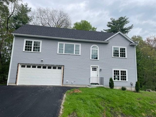 25 Ash St, Webster, MA 01570 - colonial home featuring driveway, a front lawn, and a garage