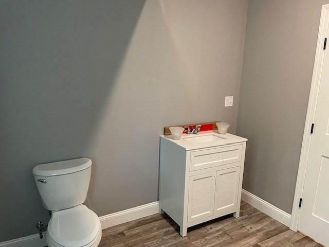 25 Ash St, Webster, MA 01570 - bathroom with wood finished floors, baseboards, toilet, and vanity