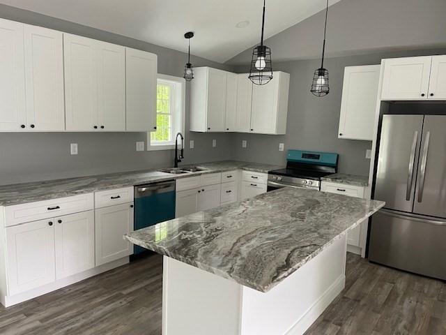 25 Ash St, Webster, MA 01570 - kitchen featuring stainless steel appliances, a sink, vaulted ceiling, dark wood finished floors, and light stone counters