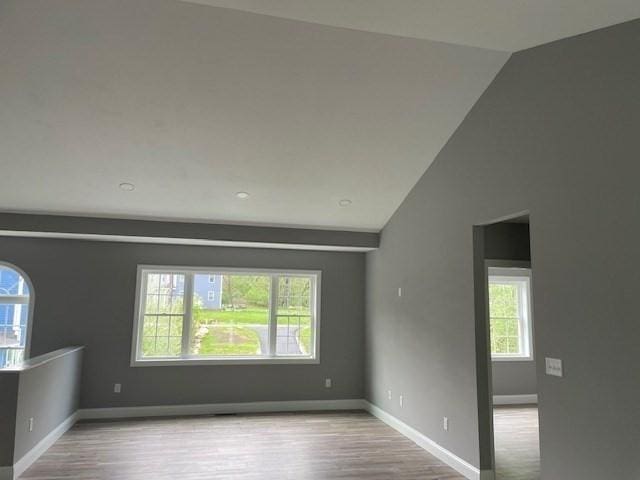 25 Ash St, Webster, MA 01570 - empty room featuring vaulted ceiling, wood finished floors, and baseboards