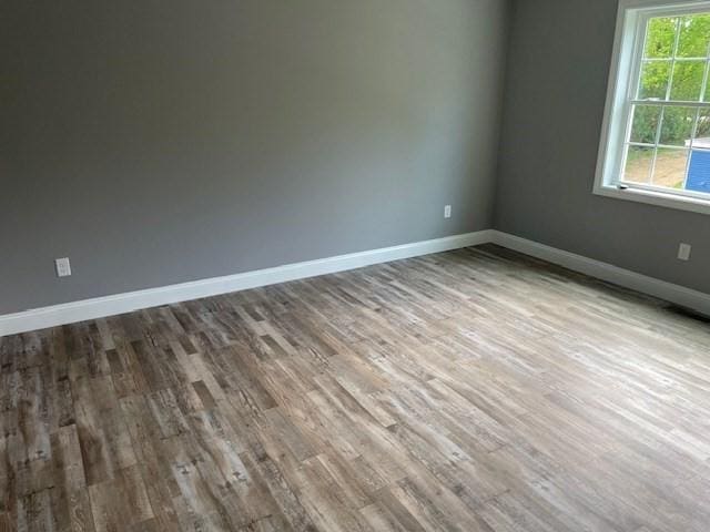 25 Ash St, Webster, MA 01570 - empty room with wood finished floors and baseboards