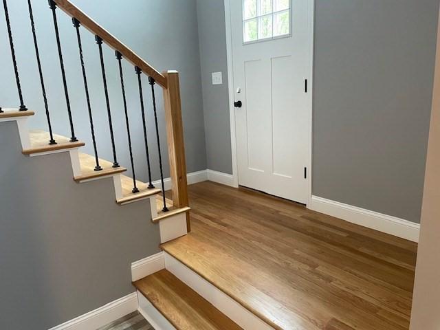 25 Ash St, Webster, MA 01570 - foyer with baseboards, stairs, and wood finished floors