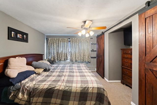140 W Mountain St, Worcester, MA 01606 - bedroom featuring a barn door, light carpet, a baseboard radiator, ceiling fan, and baseboards